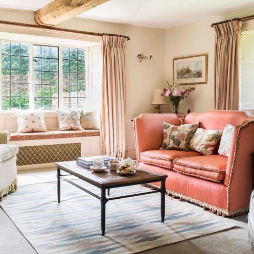 Dual aspect windows in the sitting room of one of Antonia Stewart Ltd country projects. They chose a pink/green scheme for this room to keep it fresh and warm whatever the time of the day and used different textures to create a layered, evolved feeling.