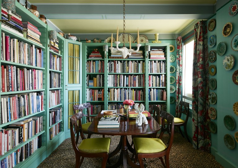 The library-dining room-office in Frank de Biasi and Gene Meyer's Park Avenue apartment. 'At 7:15AM  I make my way to my weekday home office—the end of our dining room table. This is a George III mahogany table (ex-Christie’s) with the sole weekend function of hosting dinner parties' Architectural Digest 