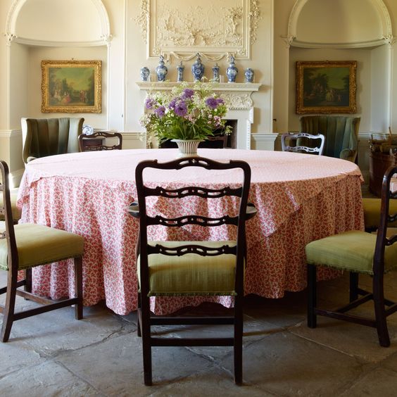 At Gateley Hall in Norfolk, owner Vivien Greenock has used her expertise as an interior designer to restore the once neglected eighteenth-century house and decorate it in a quintessential English style. In the entrance hall, which doubles as a dining room, eighteenth-century chairs surround a large circular table and a collection of Delftware is framed by the plasterwork above the chimneypiece. From the July 2014 issue of House & Garden.