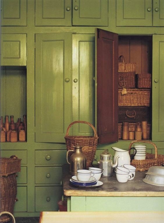 green kitchen cabinets wicker baskets the world of interiors